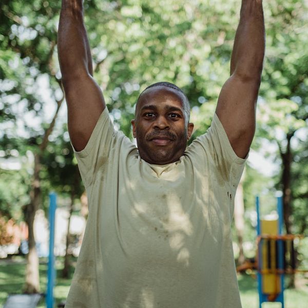 Close view of a man hands gripping a pull-up bar.